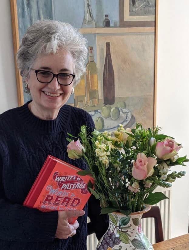 Sunday Times children's book critic Nicolette Jones holds a copy of her latest book next to a bunch of flowers